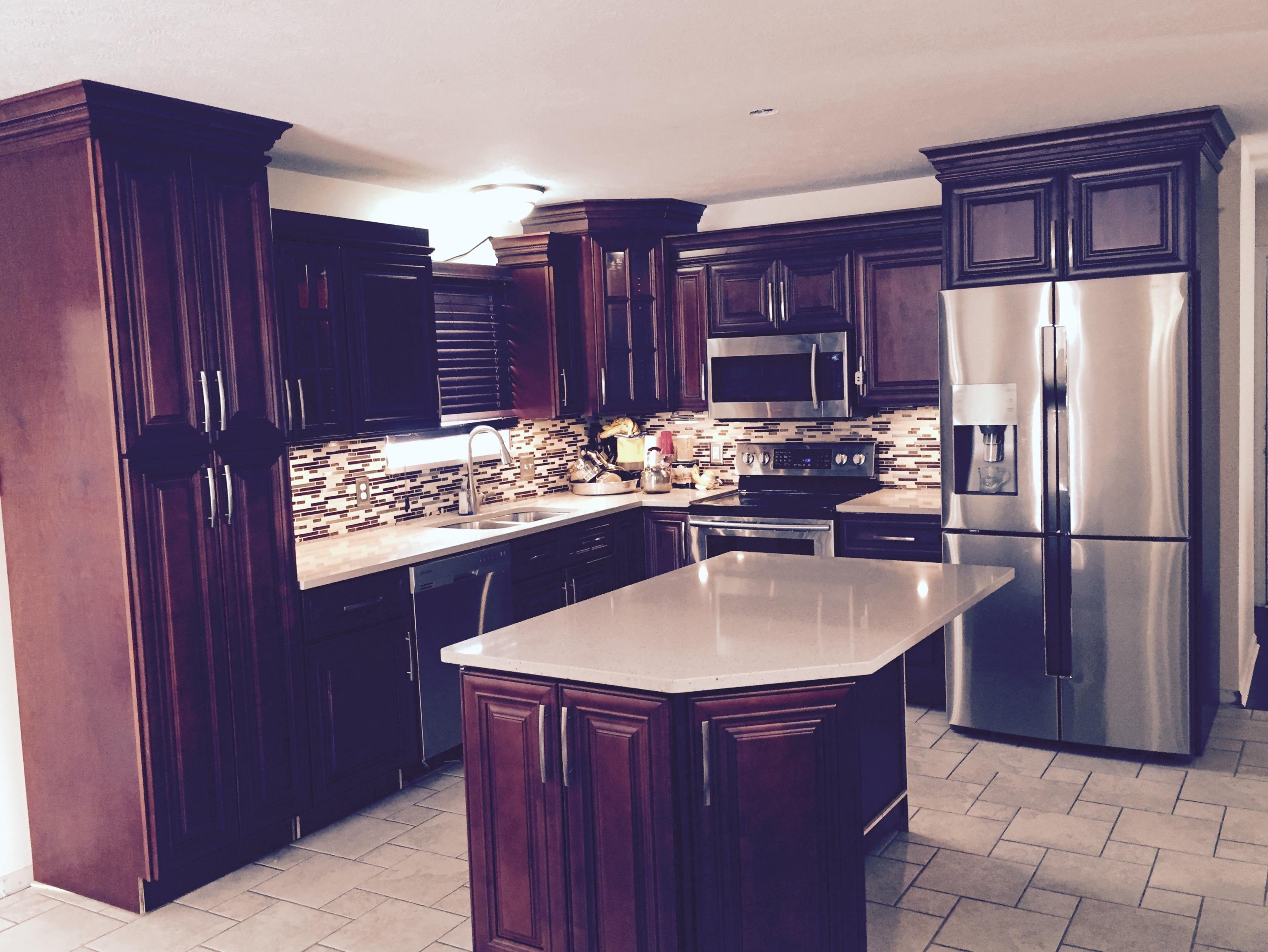 Kitchen remodel with custom dark tile backsplash by Lansing Concrete and Remodeling