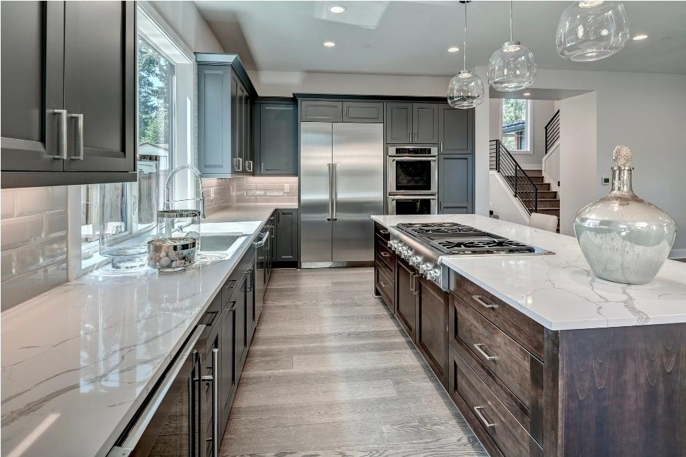 Kitchen remodel with dark cabinets and marble countertops by Lansing Concrete and Remodeling